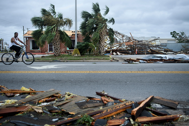 a man rides past storm damage after hurricane michael in panama city florida photo afp