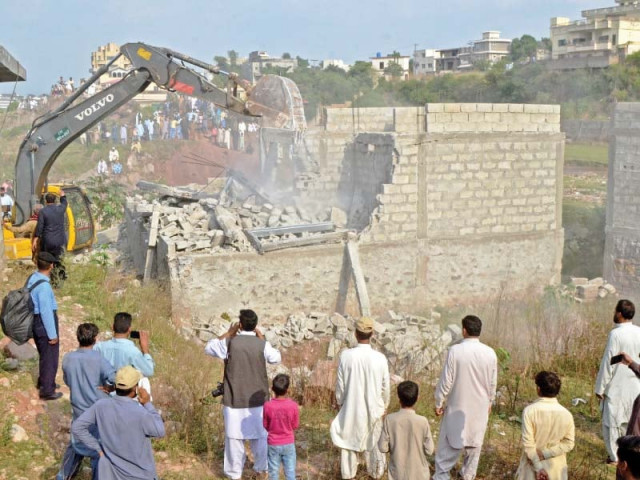 cda employees use excavators to demolish illegal structures along korang nullah photo waseem nazir express cda employees use excavators to demolish illegal structures along korang nullah photo waseem nazir express