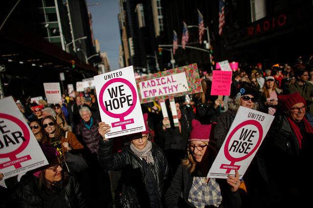 a photograph of people holding signs as they attended the womens march in new york city in january 2018 photo afp a photograph of people holding signs as they attended the womens march in new york city in january 2018 photo afp