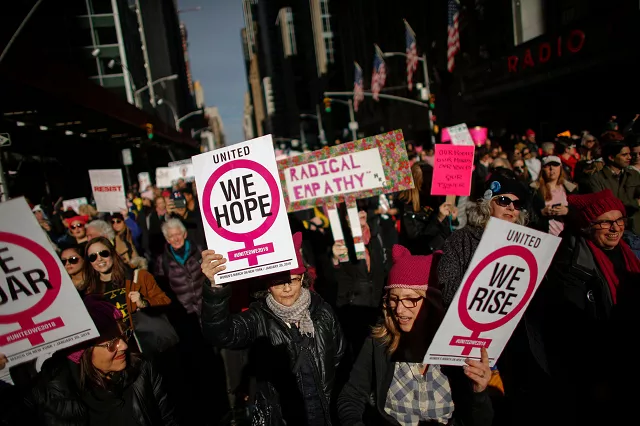 a photograph of people holding signs as they attended the womens march in new york city in january 2018 photo afp a photograph of people holding signs as they attended the womens march in new york city in january 2018 photo afp