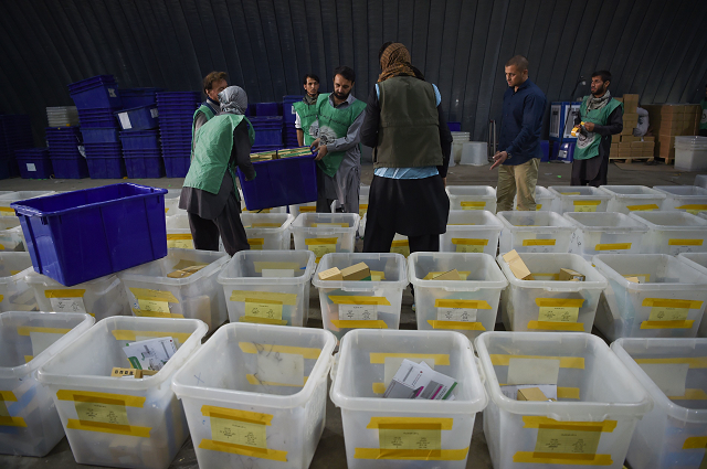 workers sort through boxes of biometric devices in kabul photo afp