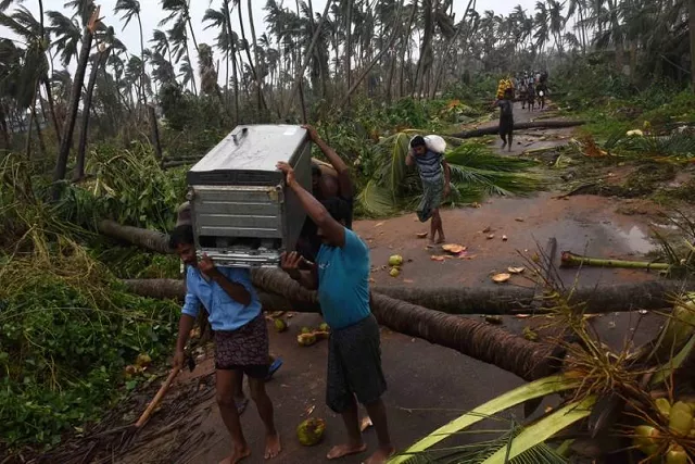 people carry their belongings to a safer place after cyclone titli hit in srikakulam district in the southern state of andhra pradesh india october 11 2018 photo reuters people carry their belongings to a safer place after cyclone titli hit in srikakulam district in the southern state of andhra pradesh india october 11 2018 photo reuters