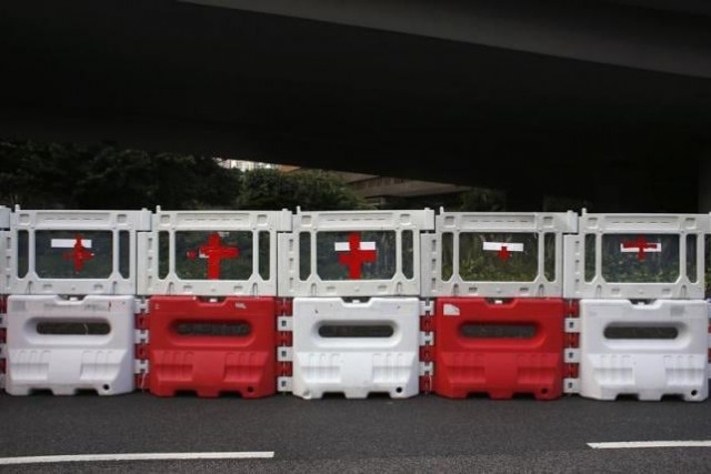 red cross signs are seen on road blocks used by protesters to set up a makeshift first aid station at the financial central district in hong kong on september 30 2014 photo reuters red cross signs are seen on road blocks used by protesters to set up a makeshift first aid station at the financial central district in hong kong on september 30 2014 photo reuters