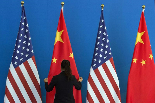 a woman is seen arranging the us china flags photo reuters