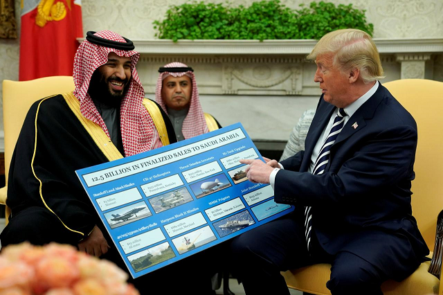 us president donald trump holds a chart of military hardware sales as he welcomes saudi arabia 039 s crown prince mohammed bin salman in the oval office at the white house in washington us march 20 2018 photo reuters