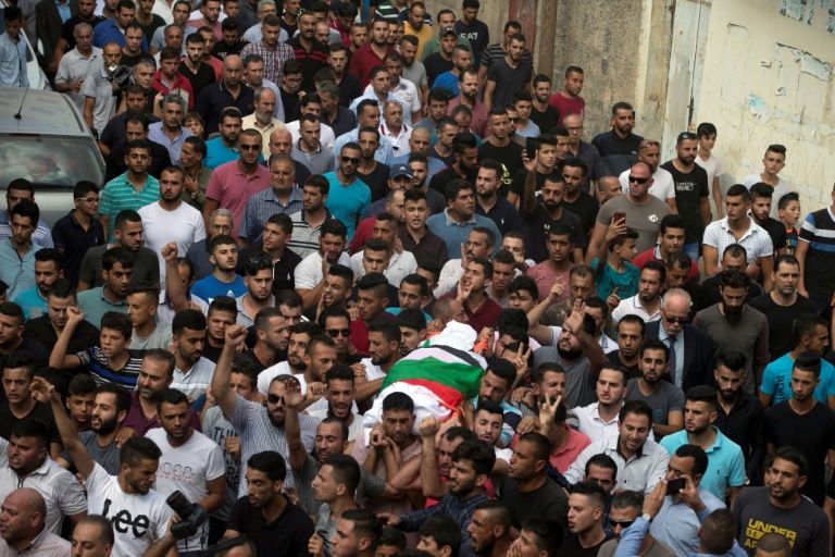 the funeral procession for palestinian aisha rabi who died of her wounds on 12 october after the car she was travelling in was hit by stones photo afp the funeral procession for palestinian aisha rabi who died of her wounds on 12 october after the car she was travelling in was hit by stones photo afp