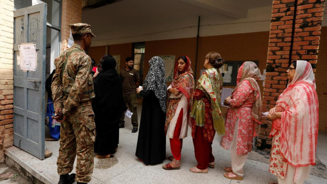a soldier keeps watch as voters line up to enter at a polling station during general elections 2018 photo reuters a soldier keeps watch as voters line up to enter at a polling station during general elections 2018 photo reuters