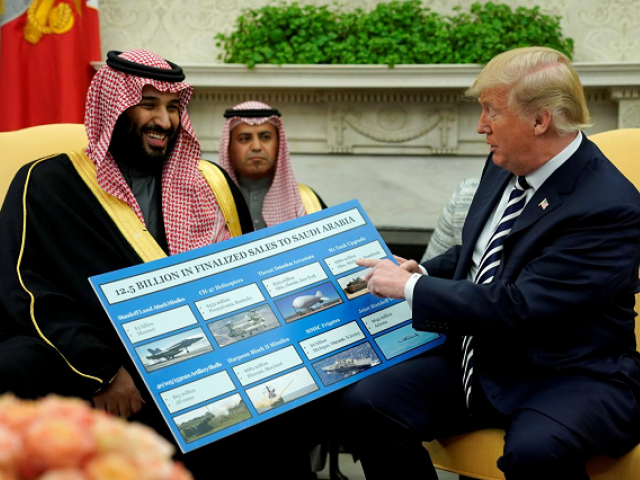 us president donald trump holds a chart of military hardware sales as he welcomes saudi arabia 039 s crown prince mohammed bin salman in the oval office at the white house in washington us march 20 2018 photo reuters