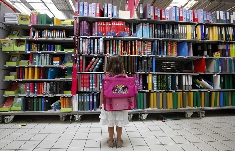 a young girl looks at school stationery in a supermarket photo reuters