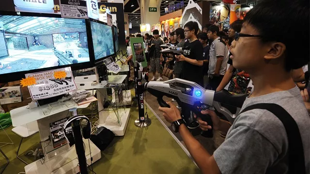 children play the latest video games at the 13th ani com comic book and game gair in hong kong on july 29 2011 photo afp children play the latest video games at the 13th ani com comic book and game gair in hong kong on july 29 2011 photo afp