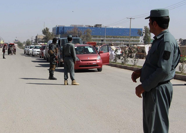 afghan policemen inspect vehicles at a checkpoint in helmand province afghanistan photo reuters