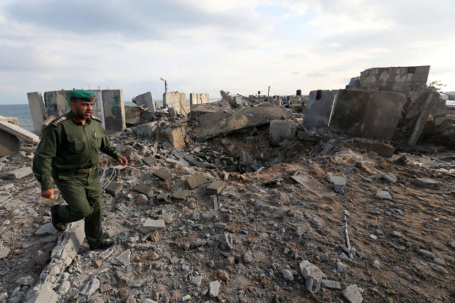 a member of palestinian security forces loyal to hamas inspects the scene of an israeli air strike in the southern gaza strip october 17 2018 photo reuters