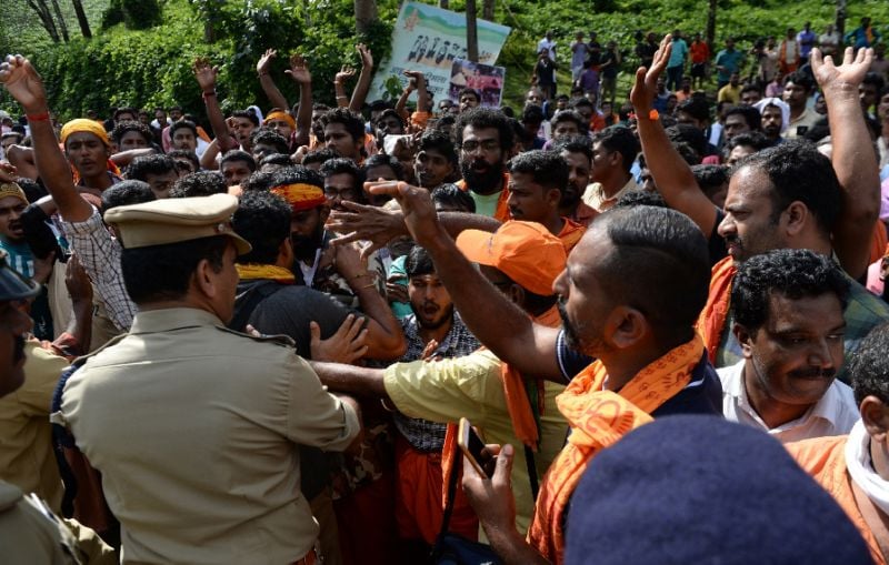 police tried to clear protesters who are against allowing women into the site photo afp