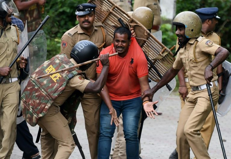 indian police beat a hindu activist in protests over women 039 s acccess to a temple in kerala photo afp