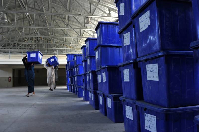 afghan election commission workers carry plastic ballot boxes at a warehouse in jalalabad photo afp