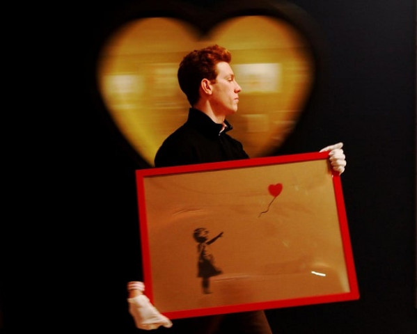 an employee walks with banksy 039 s quot girl and balloon quot 2009 at bonhams auction house in london march 23 2012 photo reuters an employee walks with banksy 039 s quot girl and balloon quot 2009 at bonhams auction house in london march 23 2012 photo reuters