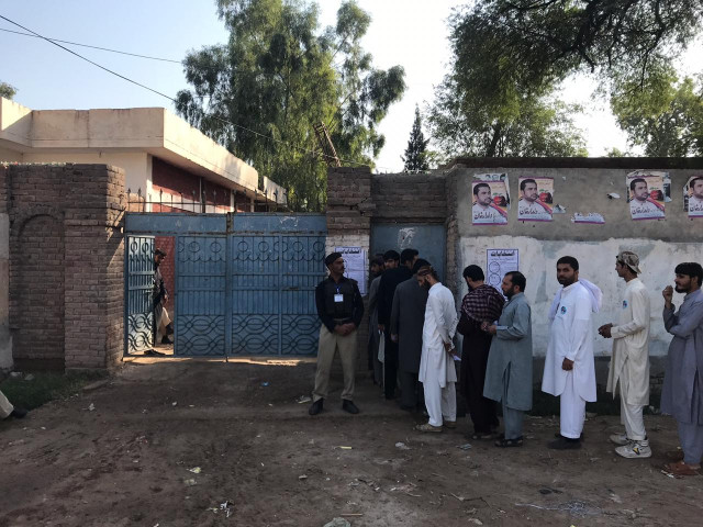 polling underway at government high school mattani photo express polling underway at government high school mattani photo express