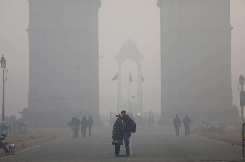 people take a selfie in front of the india gate war memorial on a smoggy winter morning in new delhi india december 26 2017 photo reuters