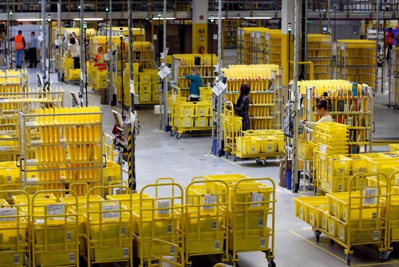 workers collect items at amazon 039 s logistics centre in graben near augsburg december 16 2013 photo reuters