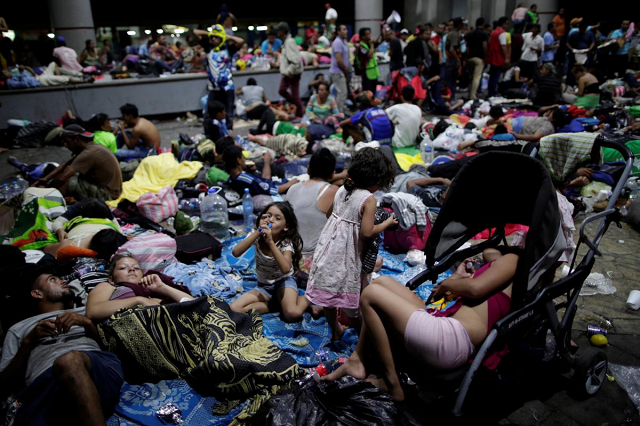 migrants part of a caravan of thousands of migrants from central america en route to the united states rest along the sidewalks of tapachula city center mexico october 21 2018 photo reuters