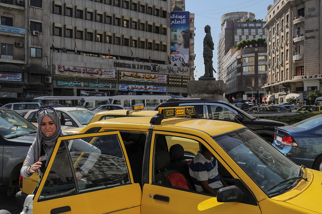 a woman exits a taxi during rush hour in central damascus syria september 16 2018 photo reuters