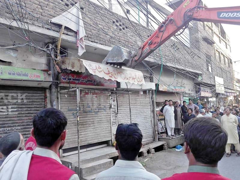 drive against encroachment civic authorities raze illegal structures clear roads