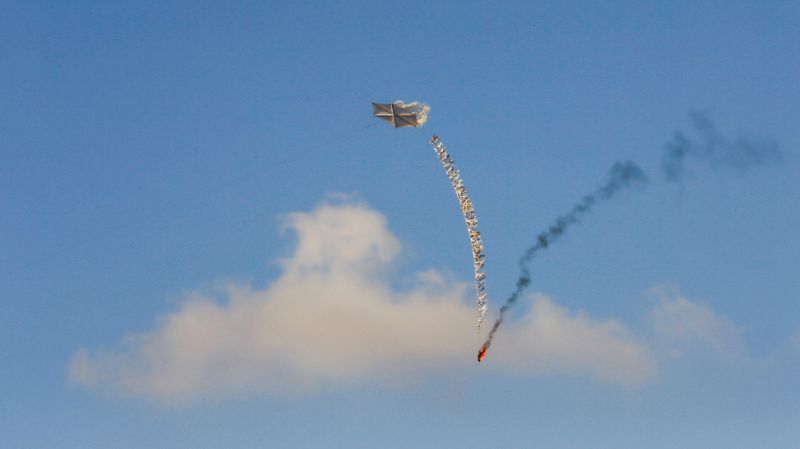 palestinian demonstrators fly a kite aiming to set fire to israeli crops following a demonstration along the border east of gaza city photo afp