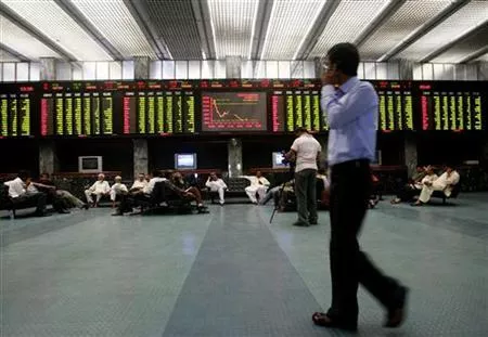 a stockbroker walks near an electronic stock exchange board inside the trading hall at the karachi photo reuters a stockbroker walks near an electronic stock exchange board inside the trading hall at the karachi photo reuters