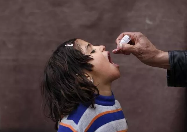 a child receives polio vaccination drops photo reuters a child receives polio vaccination drops photo reuters