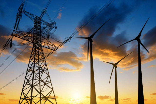 file photo of high voltage tower and wind turbines against the sunset photo afp file photo of high voltage tower and wind turbines against the sunset photo afp