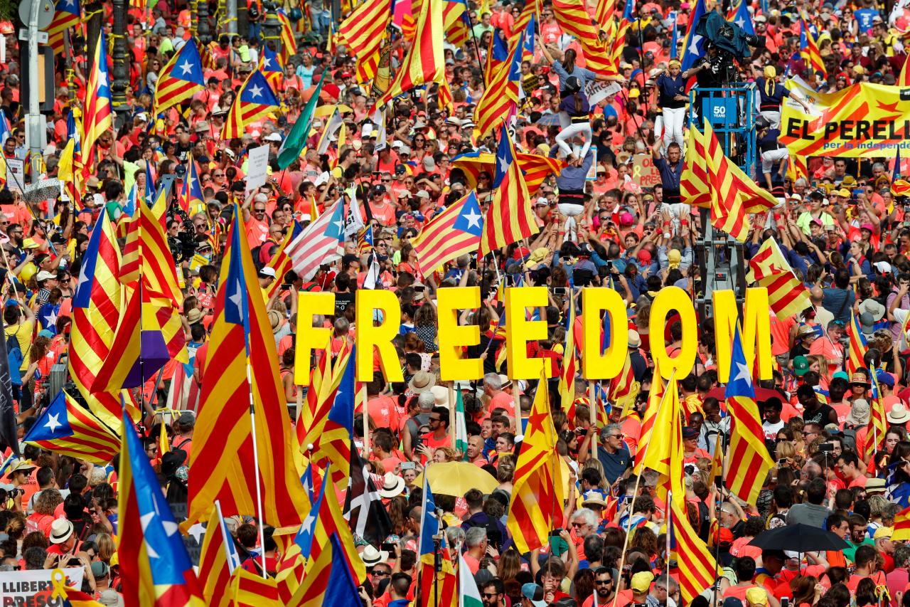 people hold up catalan separatist flags and letters spelling out quot freedom quot as they gather for a rally on catalonia 039 s national day 039 la diada 039 in barcelona spain photo reuters