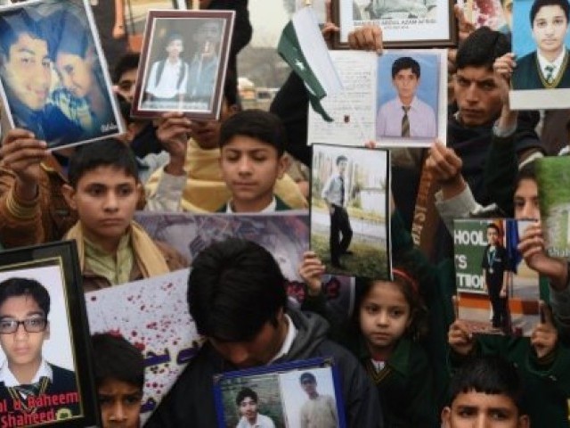 relatives of schoolchildren killed in a taliban attack on the army public school aps protest against delays in the investigation in peshawar photo afp