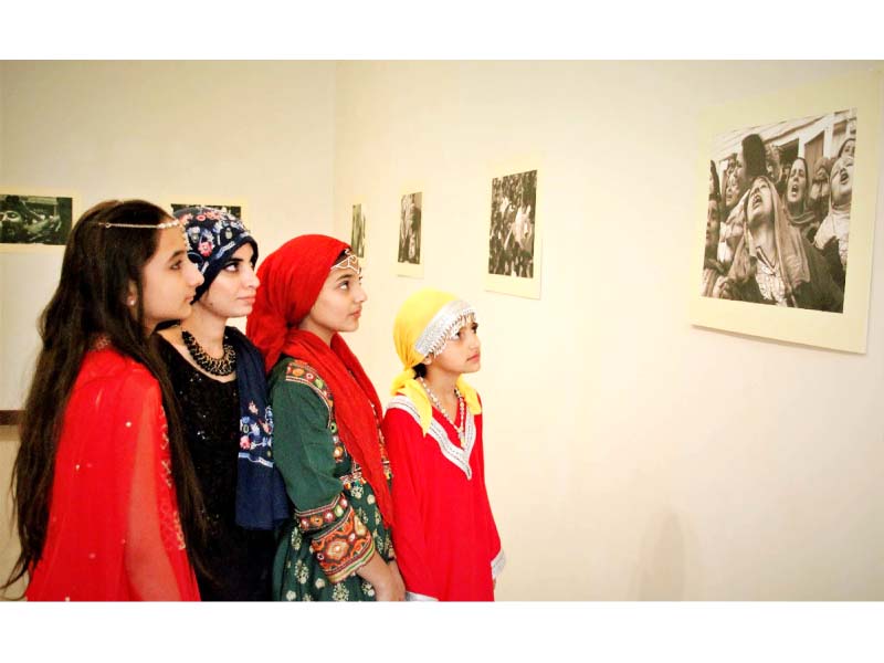 children keenly look at photos of the kashmir struggle at an exhibition organised at the pnca in islamabad to observe kashmir black day photo online