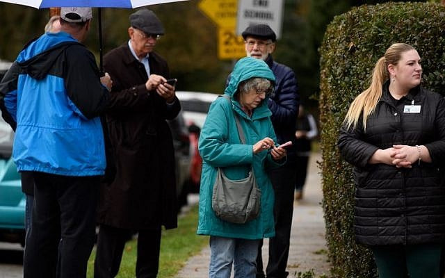 by standers check their phones outside of a synagogue after the pittsburgh shooting photo afp by standers check their phones outside of a synagogue after the pittsburgh shooting photo afp