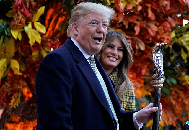 u s president donald trump waves the staff of a child dressed as a pharaoh as he and u s first lady melania trump hand out halloween candy to trick or treaters at the white house in washington photo reuters