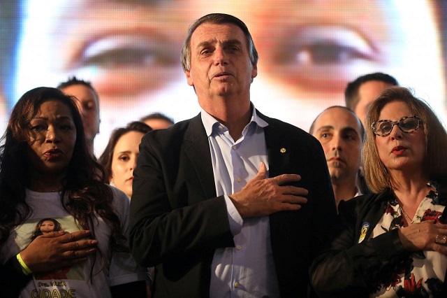 file photo presidential candidate jair bolsonaro listens to the national anthem during a meeting with women in porto alegre brazil august 30 2018 reuters diego vara file photo