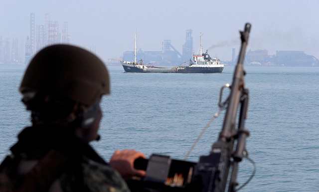 a us navy soldier onboard mark vi patrol boat stands guard as an oil tanker makes its way towards bahrain port during an exercise of us uk mine countermeasures mcmex taking place in arabian sea bahrain september 11 2018 photo reuters