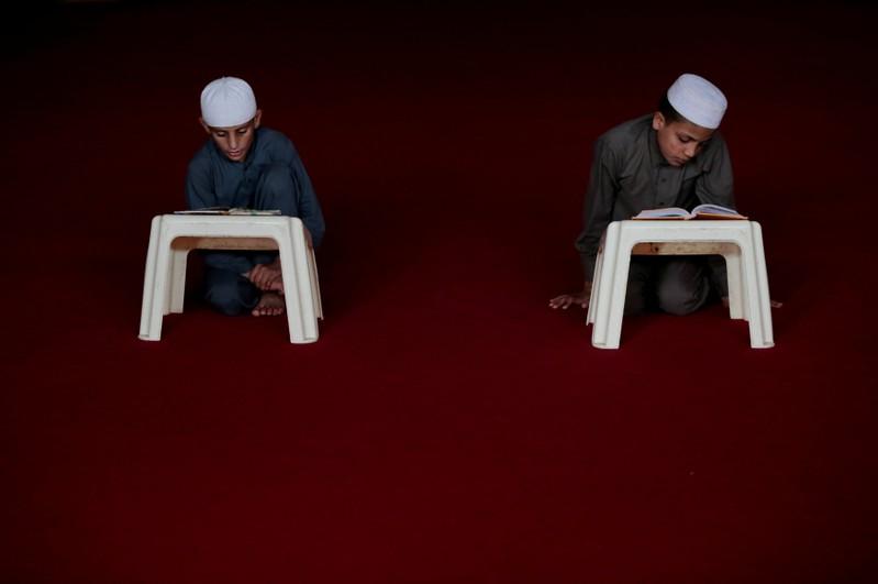 students read the holy book at a madrassa photo reuters