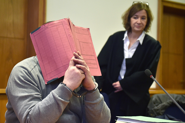 in this file photo taken on february 26 2015 german former male nurse niels hoegel hides his face behind a folder as he waits next to his lawyer ulrike baumann r for the opening of another session of his trial at a court in oldenburg northwestern germany   german nurse niels hoegel already serving a lengthy term for previous killings will go on trial before anguished relatives on october 30 2018 over the murders of around 100 more people   a spree prosecutors say is unprecedented in the post war period photo afp