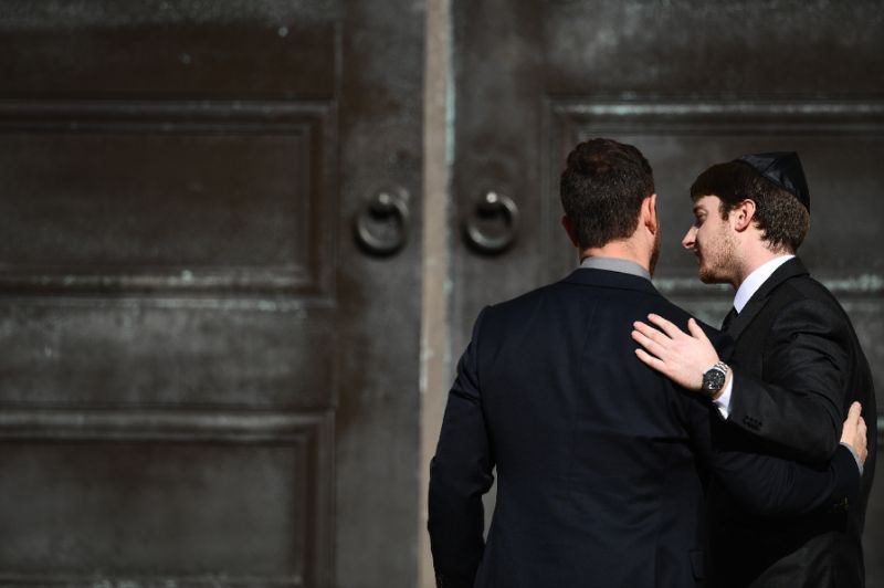 two men embrace as they arrive at the rodef shalom congregation for the funeral of cecil and david rosenthal brothers who were among the 11 victims of a mass shooting at the tree of life synagogue in pittsburgh pennsylvania photo afp