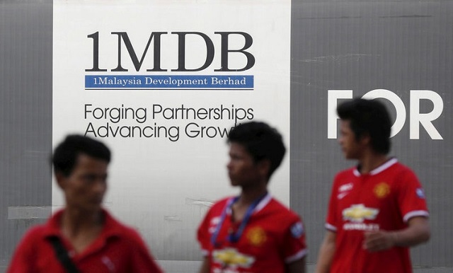 men walk past a 1malaysia development berhad 1mdb billboard at the fund 039 s flagship tun razak exchange development in kuala lumpur march 1 2015 reuters file