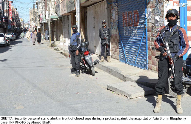 security officials stand alert outside closed shops in quetta photo inp security officials stand alert outside closed shops in quetta photo inp