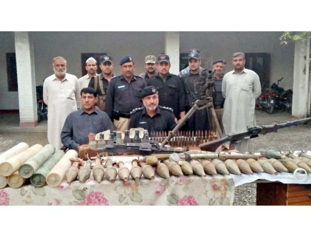 exhumed police recover arms ammo from grave