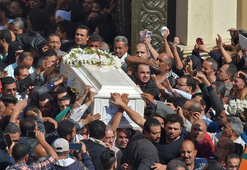 coptic christians carry the coffin of a victim killed in an is claimed attack that took place on friday against pilgrims in egypt 039 s minya province photo afp