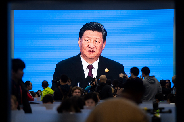 china 039 s president xi jinping is seen on a big screen in the media centre as he speaks at the opening ceremony of the first china international import expo ciie in shanghai on november 5 2018 photo afp