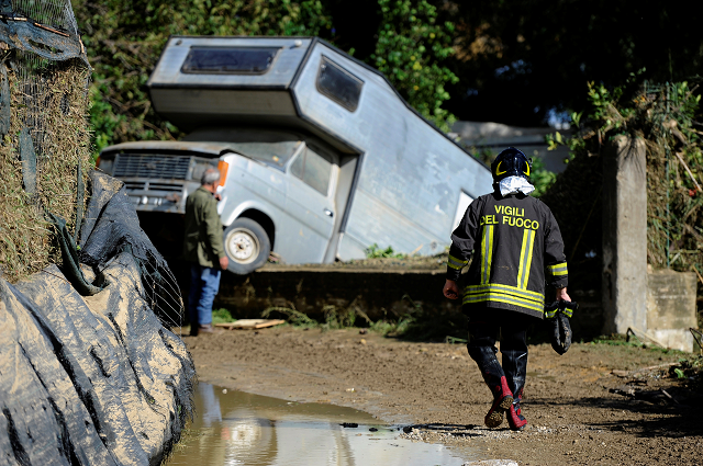 a fireman walks on a mud covered path in the aftermath of a flood in casteldaccia near palermo italy november 4 2018 photo reuters a fireman walks on a mud covered path in the aftermath of a flood in casteldaccia near palermo italy november 4 2018 photo reuters