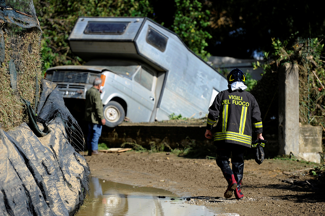 a fireman walks on a mud covered path in the aftermath of a flood in casteldaccia near palermo italy november 4 2018 photo reuters