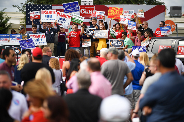 supporters await the arrival of republican candidate for governor of florida ron desantis as they attend a rally at freedom pharmacy on the final day of campaigning in the midterm elections photo afp