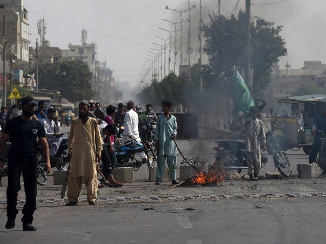 tlp supporters on a blocked street during protests photo afp