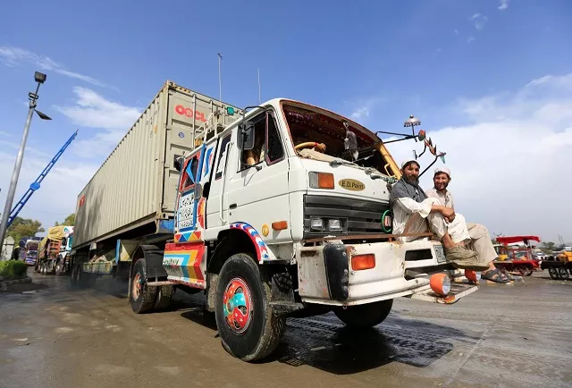 file photo afghan men sit in front of supply trucks carrying containers for export at the customhouse in jalalabad afghanistan may 14 2018 photo reuters file photo afghan men sit in front of supply trucks carrying containers for export at the customhouse in jalalabad afghanistan may 14 2018 photo reuters